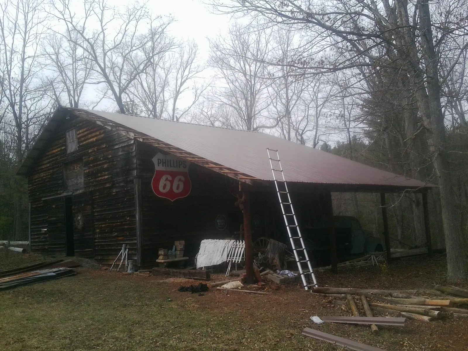 New metal roof on an open sided timber barn with a vintage sign in Springdale